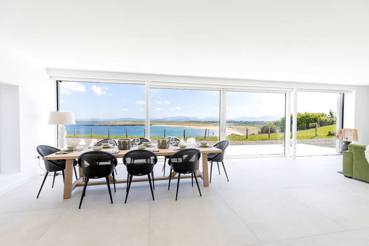 Dining table and folding doors at Golden Strand View cottage