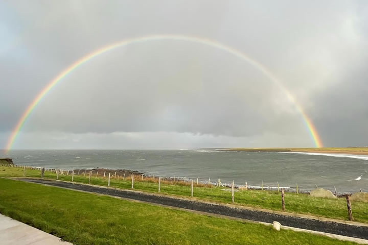 Rainbow over Golden Strand beach and bay, viewed from Golden Strand View luxury holiday home, Achill Island, Ireland